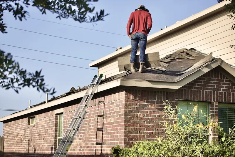 Professional roofer working on a residential roof in Tapleyville
